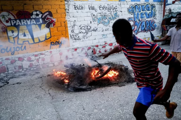 Suspected Haiti gang members set on fire as conflict spreads to capital suburb